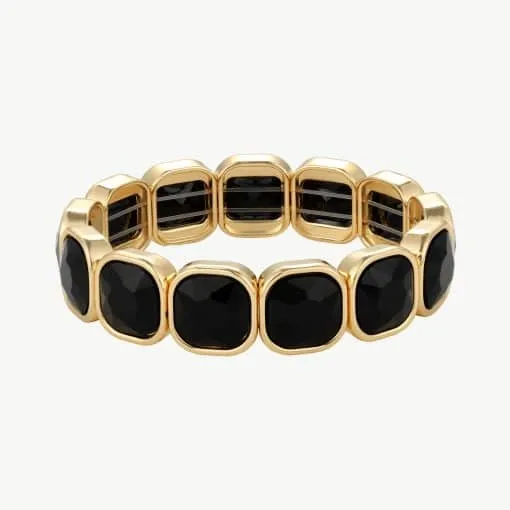 Erlebe, wie das goldene Armband mit markanten schwarzen Edelsteinen deinen Look modern und luxuriös in Szene setzt.