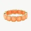 Erlebe modernen Luxus: Trage dieses goldene Armband mit leuchtend orangen Steinen und setze ein stylishes Statement!.