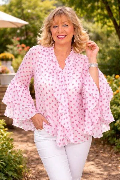 Sommerliche Punkteprinzessin Bluse: Modell mit rosa Punkten und weiten Ärmeln. Elegante Damenmode für den Sommer.