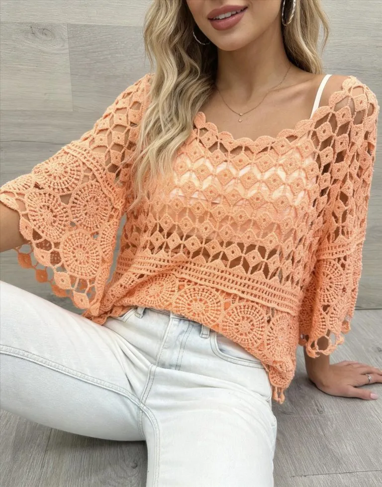 Modell trägt gehäkelte Tunika in Pfirsichfarbe, lässiger Sommerlook. Modische Tunika mit Jeans.